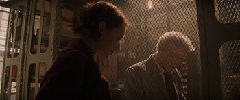 Movie still from “Indiana Jones and the Dial of Destiny” (2023), directed by James Mangold – A woman standing next to a man in a suit; Medium shot, Low angle