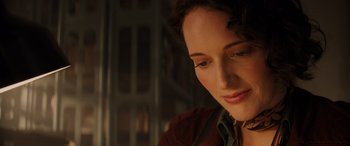 Movie still from “Indiana Jones and the Dial of Destiny” (2023), directed by James Mangold – A woman's face in a dark room; Close Up shot, Low angle