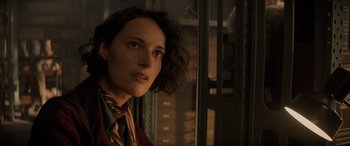 Movie still from “Indiana Jones and the Dial of Destiny” (2023), directed by James Mangold – A woman in a red jacket and a brown tie; Close Up shot, Low angle