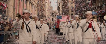 Movie still from “Indiana Jones and the Dial of Destiny” (2023), directed by James Mangold – A group of sailors marching down a street; Extreme Wide shot, High angle