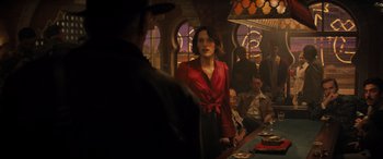Movie still from “Indiana Jones and the Dial of Destiny” (2023), directed by James Mangold – A woman standing at a bar in front of a man; Medium shot, Over the shoulder angle