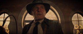 Movie still from “Indiana Jones and the Dial of Destiny” (2023), directed by James Mangold – An older man wearing a hat and a leather jacket; Close Up shot, Low angle