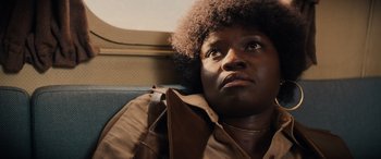 Movie still from “Indiana Jones and the Dial of Destiny” (2023), directed by James Mangold – A person sitting on a train looking up at the sky; Close Up shot, Low angle