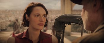 Movie still from “Indiana Jones and the Dial of Destiny” (2023), directed by James Mangold – A person wearing a red shirt; Close Up shot, Over the shoulder angle