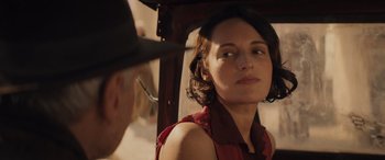 Movie still from “Indiana Jones and the Dial of Destiny” (2023), directed by James Mangold – A woman in a red shirt and a man in a black hat; Close Up shot, Over the shoulder angle