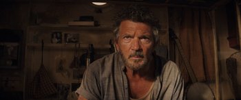 Movie still from “Indiana Jones and the Dial of Destiny” (2023), directed by James Mangold – A person wearing a shirt; Close Up shot, Low angle