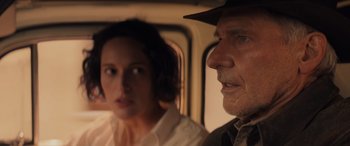 Movie still from “Indiana Jones and the Dial of Destiny” (2023), directed by James Mangold – A man and a woman are looking out a window; Close Up shot, Over the shoulder angle