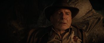 Movie still from “Indiana Jones and the Dial of Destiny” (2023), directed by James Mangold – An older man wearing a brown hat and a brown jacket; Close Up shot, Overhead angle