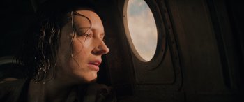 Movie still from “Indiana Jones and the Dial of Destiny” (2023), directed by James Mangold – A woman looking out of an airplane window at the sky; Close Up shot, Low angle