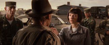 Movie still from “Indiana Jones and the Kingdom of the Crystal Skull” (2008), directed by Steven Spielberg – A man and a woman standing next to each other in front of a car; Close Up shot, Over the shoulder angle