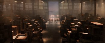 Movie still from “Indiana Jones and the Kingdom of the Crystal Skull” (2008), directed by Steven Spielberg – A group of people standing in an industrial setting; Extreme Wide shot, High angle