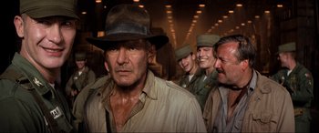 Movie still from “Indiana Jones and the Kingdom of the Crystal Skull” (2008), directed by Steven Spielberg – A group of men in uniform standing next to each other; Medium shot, Over the shoulder angle