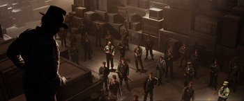 Movie still from “Indiana Jones and the Kingdom of the Crystal Skull” (2008), directed by Steven Spielberg – A group of men standing in a room with boxes on the ground; Extreme Wide shot, High angle