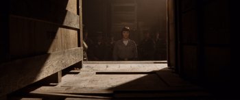 Movie still from “Indiana Jones and the Kingdom of the Crystal Skull” (2008), directed by Steven Spielberg – A group of people standing in front of a mirror; Wide shot, Low angle