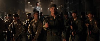 Movie still from “Indiana Jones and the Kingdom of the Crystal Skull” (2008), directed by Steven Spielberg – A group of men in uniform standing in a room; Medium shot, Low angle