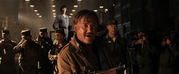Movie still from “Indiana Jones and the Kingdom of the Crystal Skull” (2008), directed by Steven Spielberg – A group of men in military fatigues standing next to each other; Close Up shot, Low angle
