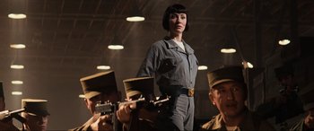 Movie still from “Indiana Jones and the Kingdom of the Crystal Skull” (2008), directed by Steven Spielberg – A woman standing in front of a group of soldiers; Medium shot, Low angle