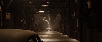 Movie still from “Indiana Jones and the Kingdom of the Crystal Skull” (2008), directed by Steven Spielberg – A car driving down a street in an industrial setting; Extreme Wide shot, High angle