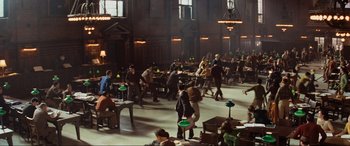 Movie still from “Indiana Jones and the Kingdom of the Crystal Skull” (2008), directed by Steven Spielberg – A group of people sitting at tables in a room; Extreme Wide shot, High angle