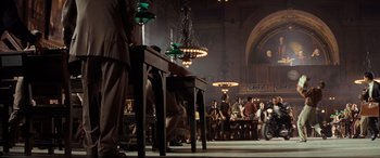 Movie still from “Indiana Jones and the Kingdom of the Crystal Skull” (2008), directed by Steven Spielberg – A group of people standing in a large room; Wide shot, Low angle