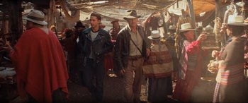 Movie still from “Indiana Jones and the Kingdom of the Crystal Skull” (2008), directed by Steven Spielberg – A group of people walking in a field; Medium shot, Over the shoulder angle