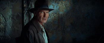 Movie still from “Indiana Jones and the Kingdom of the Crystal Skull” (2008), directed by Steven Spielberg – A man wearing a hat standing in front of a wall; Close Up shot, Over the shoulder angle
