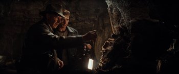 Movie still from “Indiana Jones and the Kingdom of the Crystal Skull” (2008), directed by Steven Spielberg – A couple of men standing next to each other in a cave; Medium shot, Low angle