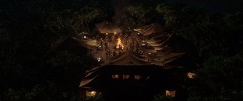 Movie still from “Indiana Jones and the Kingdom of the Crystal Skull” (2008), directed by Steven Spielberg – A group of tents set up in the woods at night; Extreme Wide shot, High angle
