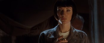 Movie still from “Indiana Jones and the Kingdom of the Crystal Skull” (2008), directed by Steven Spielberg – A woman with a short hair cut is holding a ring in her hand; Close Up shot, Low angle
