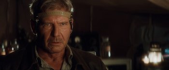 Movie still from “Indiana Jones and the Kingdom of the Crystal Skull” (2008), directed by Steven Spielberg – A person wearing a head band; Close Up shot, Over the shoulder angle