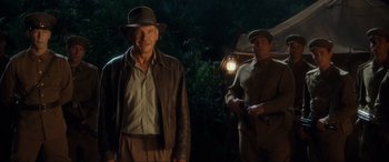 Movie still from “Indiana Jones and the Kingdom of the Crystal Skull” (2008), directed by Steven Spielberg – A man and a woman standing next to each other in front of a lamp; Medium shot, Over the shoulder angle