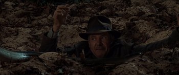 Movie still from “Indiana Jones and the Kingdom of the Crystal Skull” (2008), directed by Steven Spielberg – An old man in a hat is in the dirt; Close Up shot, Overhead angle