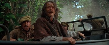 Movie still from “Indiana Jones and the Kingdom of the Crystal Skull” (2008), directed by Steven Spielberg – An old man sitting on a bench in front of a forest; Medium shot, Over the shoulder angle