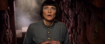 Movie still from “Indiana Jones and the Kingdom of the Crystal Skull” (2008), directed by Steven Spielberg – A woman in a military uniform looking surprised; Close Up shot, Over the shoulder angle