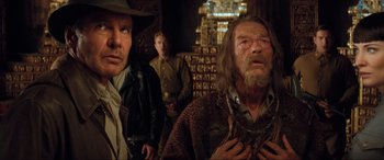 Movie still from “Indiana Jones and the Kingdom of the Crystal Skull” (2008), directed by Steven Spielberg – A group of men standing next to each other in a room; Close Up shot, Over the shoulder angle