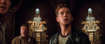 Movie still from “Indiana Jones and the Kingdom of the Crystal Skull” (2008), directed by Steven Spielberg – A man standing in front of a skeleton in a room; Close Up shot, Low angle