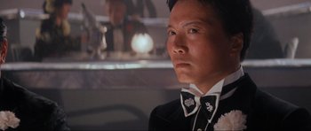 Movie still from “Indiana Jones and the Temple of Doom” (1984), directed by Steven Spielberg – A man in a suit and bow tie looking to his left; Close Up shot, Low angle