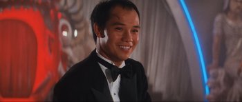 Movie still from “Indiana Jones and the Temple of Doom” (1984), directed by Steven Spielberg – A man in a tuxedo smiling for the camera; Close Up shot, Low angle