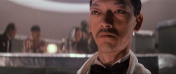 Movie still from “Indiana Jones and the Temple of Doom” (1984), directed by Steven Spielberg – A person wearing a bow tie; Close Up shot, Low angle