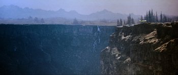 Movie still from “Indiana Jones and the Temple of Doom” (1984), directed by Steven Spielberg – A view of a mountain from a cliff; Extreme Wide shot, High angle