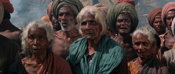 Movie still from “Indiana Jones and the Temple of Doom” (1984), directed by Steven Spielberg – A group of men standing next to each other; Medium shot, High angle