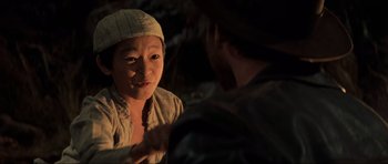 Movie still from “Indiana Jones and the Temple of Doom” (1984), directed by Steven Spielberg – A woman is talking to a man in a forest; Close Up shot, Over the shoulder angle