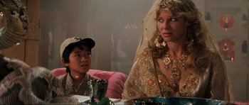 Movie still from “Indiana Jones and the Temple of Doom” (1984), directed by Steven Spielberg – A man and a woman sitting at a dinner table; Close Up shot, Over the shoulder angle