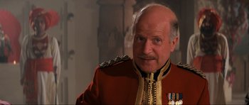 Movie still from “Indiana Jones and the Temple of Doom” (1984), directed by Steven Spielberg – An older man in a red military uniform; Close Up shot, Low angle