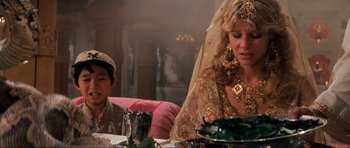 Movie still from “Indiana Jones and the Temple of Doom” (1984), directed by Steven Spielberg – A man and a woman sitting at a dinner table; Close Up shot, Over the shoulder angle