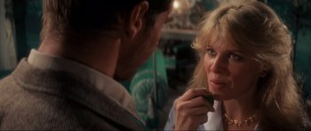 Movie still from “Indiana Jones and the Temple of Doom” (1984), directed by Steven Spielberg – A man and a woman looking at one another; Close Up shot, Over the shoulder angle