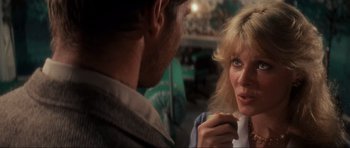 Movie still from “Indiana Jones and the Temple of Doom” (1984), directed by Steven Spielberg – A man and a woman looking at one another; Close Up shot, Over the shoulder angle
