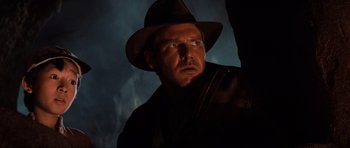 Movie still from “Indiana Jones and the Temple of Doom” (1984), directed by Steven Spielberg – A person wearing a hat; Close Up shot, Low angle