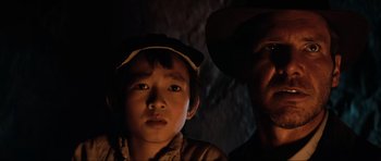 Movie still from “Indiana Jones and the Temple of Doom” (1984), directed by Steven Spielberg – A man and a boy in the dark; Close Up shot, Low angle
