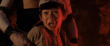 Movie still from “Indiana Jones and the Temple of Doom” (1984), directed by Steven Spielberg – A young boy wearing a hat and a jacket; Close Up shot, Low angle